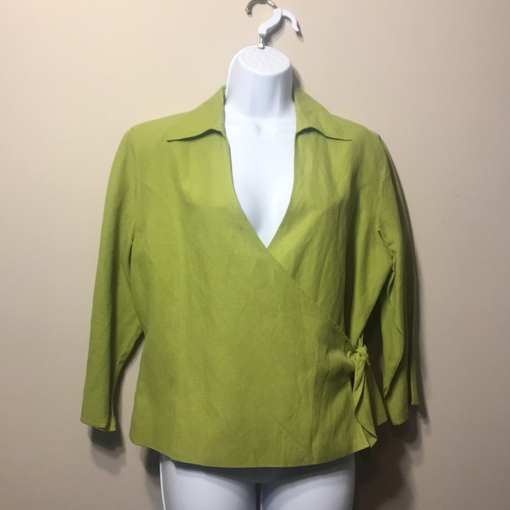 New. Never worn. Green blouse with accent bow.